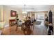 Elegant dining area adjacent to the living room with hardwood floors and natural light at 1702 Cordova Green, Seminole, FL 33777
