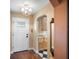 Welcoming entryway features hardwood floors, an elegant chandelier, and a convenient storage area at 1702 Cordova Green, Seminole, FL 33777
