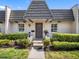 Charming front exterior featuring well-maintained landscaping and a unique roofline at 1702 Cordova Green, Seminole, FL 33777