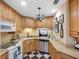 Well-lit kitchen featuring ample cabinetry, stainless steel appliances, and a modern black and white floor at 1702 Cordova Green, Seminole, FL 33777