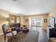 Comfortable living room featuring hardwood floors, stylish furnishings, and access to the patio at 1702 Cordova Green, Seminole, FL 33777