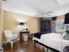 Comfortable main bedroom with hardwood floors, ceiling fan, and decorative accents at 1702 Cordova Green, Seminole, FL 33777