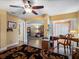 Bright home office featuring a desk, stylish rug, and connection to the living room at 1702 Cordova Green, Seminole, FL 33777