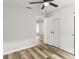 Bedroom boasts wood-look laminate flooring, a ceiling fan, and neutral paint colors at 1807 Marvy Ave, Tampa, FL 33612