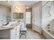 Bathroom with double sinks, ample counter space, and bathtub with shower at 1912 Blue Sage Ct, Brandon, FL 33511