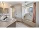 Bathroom with double sinks, ample counter space, and bathtub with shower at 1912 Blue Sage Ct, Brandon, FL 33511