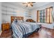 Cozy bedroom features wood floors, large window, and built in shelves for maximized storage at 1912 Blue Sage Ct, Brandon, FL 33511