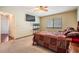Cozy bedroom with a ceiling fan, carpet flooring, and a window for natural light at 1912 Blue Sage Ct, Brandon, FL 33511