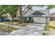 Charming single Gathering home with lush landscaping, mature trees, and attached two car garage at 1912 Blue Sage Ct, Brandon, FL 33511