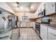 Functional eat-in kitchen featuring white cabinets, stainless steel appliances, and tile floors at 1912 Blue Sage Ct, Brandon, FL 33511