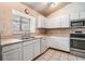 Bright kitchen features white cabinets, stainless steel appliances, and lots of counter space at 1912 Blue Sage Ct, Brandon, FL 33511