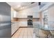 Bright kitchen with white cabinetry, stainless steel appliances, and breakfast nook at 1912 Blue Sage Ct, Brandon, FL 33511