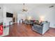 Open-concept living room featuring vaulted ceilings, fireplace and a comfortable seating arrangement at 1912 Blue Sage Ct, Brandon, FL 33511