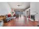 Comfortable living room with hardwood floors, fireplace, sliding door access to the pool at 1912 Blue Sage Ct, Brandon, FL 33511