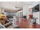 Spacious living room featuring vaulted ceilings, a cozy fireplace, hardwood floors and pool access at 1912 Blue Sage Ct, Brandon, FL 33511