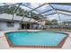 Relaxing screened-in pool with brick border, spacious patio, and a serene backyard view at 1912 Blue Sage Ct, Brandon, FL 33511