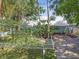 Aerial view showcasing a well-maintained home, picket fence, and lush landscaping at 2014 E Broad St, Tampa, FL 33610