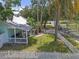 Aerial view showcasing the home, a charming white picket fence, and lush landscaping at 2014 E Broad St, Tampa, FL 33610