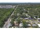 An aerial view of a neighborhood with mature trees and distant city skyline at 2014 E Broad St, Tampa, FL 33610