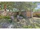 Serene backyard with outdoor seating nestled beneath mature trees and lush greenery at 2014 E Broad St, Tampa, FL 33610