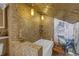 Elegant bathroom with a jetted tub, stone accents and a decorative mural at 2014 E Broad St, Tampa, FL 33610