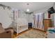 Adorable Bedroom featuring stylish tropical leaf wallpaper, wood floors and whimsical curtains at 2014 E Broad St, Tampa, FL 33610