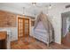 Bedroom featuring exposed brick, playful decor, unique lighting, and stylish flooring at 2014 E Broad St, Tampa, FL 33610