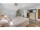 Unique bedroom featuring wood-look flooring, vintage furniture, and access to a small bathroom at 2014 E Broad St, Tampa, FL 33610