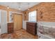 Charming bedroom featuring exposed brick, decorative touches, and wood flooring at 2014 E Broad St, Tampa, FL 33610