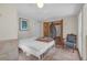 Bedroom featuring french doors to the Bedroom, an antique chair, and unique tile flooring at 2014 E Broad St, Tampa, FL 33610