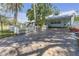 Charming home with a freshly painted exterior, a white picket fence, and a paved driveway at 2014 E Broad St, Tampa, FL 33610