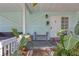 Inviting front porch with a bench, lush plants and a decorative front door at 2014 E Broad St, Tampa, FL 33610