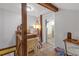 Upstairs hallway featuring wooden beams and trim leading to the bedroom and bathroom areas at 2014 E Broad St, Tampa, FL 33610