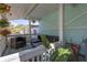 Relaxing porch featuring outdoor furniture and views of the surrounding yard at 2014 E Broad St, Tampa, FL 33610