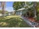 Picturesque yard with lush green lawn and charming stone pathway leading to a inviting porch at 2014 E Broad St, Tampa, FL 33610