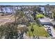Scenic aerial view of a lakefront property with a pool and lush greenery at 21918 Shamu Dr, Land O Lakes, FL 34639