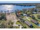 Aerial view of a lakeside property with surrounding trees and a serene waterfront at 21918 Shamu Dr, Land O Lakes, FL 34639