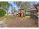 Backyard featuring mature trees, tree house, and a lake view at 21918 Shamu Dr, Land O Lakes, FL 34639