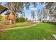 Backyard with large trees, a treehouse, and lake view at 21918 Shamu Dr, Land O Lakes, FL 34639