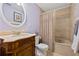 Bathroom with a carved vanity, decorative mirror, and shower-tub combination at 21918 Shamu Dr, Land O Lakes, FL 34639