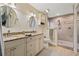 Bathroom featuring double vanity, tile flooring, and a tiled walk-in shower at 21918 Shamu Dr, Land O Lakes, FL 34639
