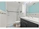 Bathroom with a white tile shower and a dark vanity with double sinks at 21918 Shamu Dr, Land O Lakes, FL 34639