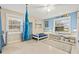 This bedroom has an interesting blue color scheme, with storage, art, and musical instruments at 21918 Shamu Dr, Land O Lakes, FL 34639