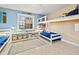 This bedroom has bunkbeds, storage, and blue accents at 21918 Shamu Dr, Land O Lakes, FL 34639