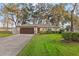 Charming single-story home featuring a well-manicured lawn, neutral exterior, and an attached two-car garage at 21918 Shamu Dr, Land O Lakes, FL 34639