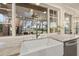 A kitchen with large window overlooking an outdoor living area with string lights, play area, and lake at 21918 Shamu Dr, Land O Lakes, FL 34639