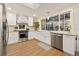 Updated kitchen features bright white cabinets, stainless steel appliances, and a large farmhouse sink at 21918 Shamu Dr, Land O Lakes, FL 34639