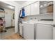 Bright laundry room with white cabinets and appliances at 21918 Shamu Dr, Land O Lakes, FL 34639