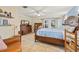 Spacious main bedroom featuring light blue walls, dark wood furniture, and French doors at 21918 Shamu Dr, Land O Lakes, FL 34639