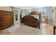 Spacious main bedroom with beautiful wood furniture, tile floors and french doors at 21918 Shamu Dr, Land O Lakes, FL 34639